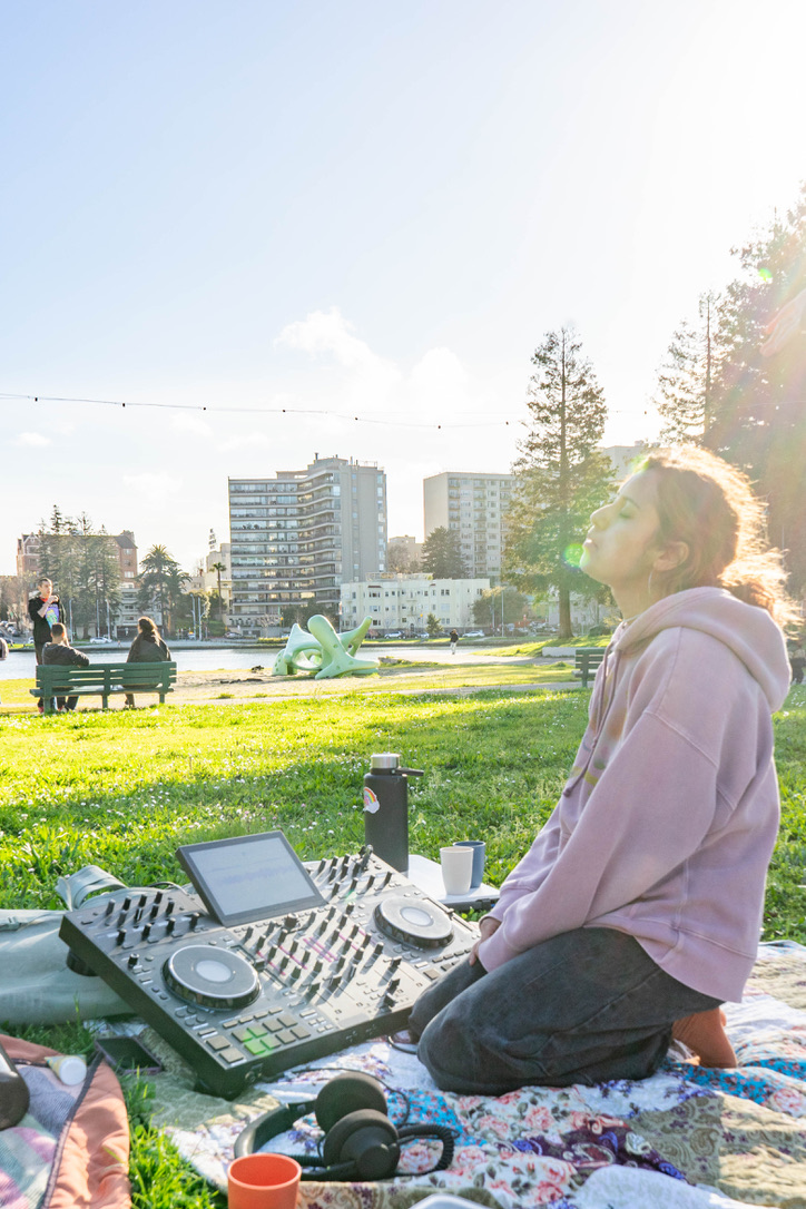 Lake Merritt Set in the sunshine with three friends on the ground